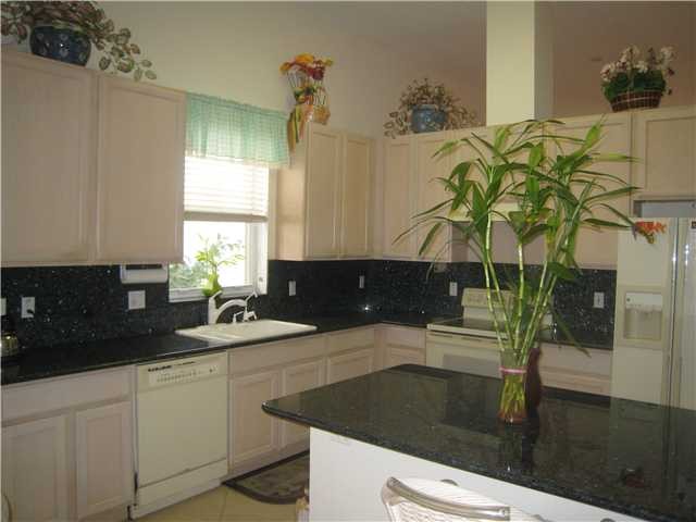 kitchen large open kitchen with granite coutners, pullouts in cabinets, breakfast bar, and culligan water system.